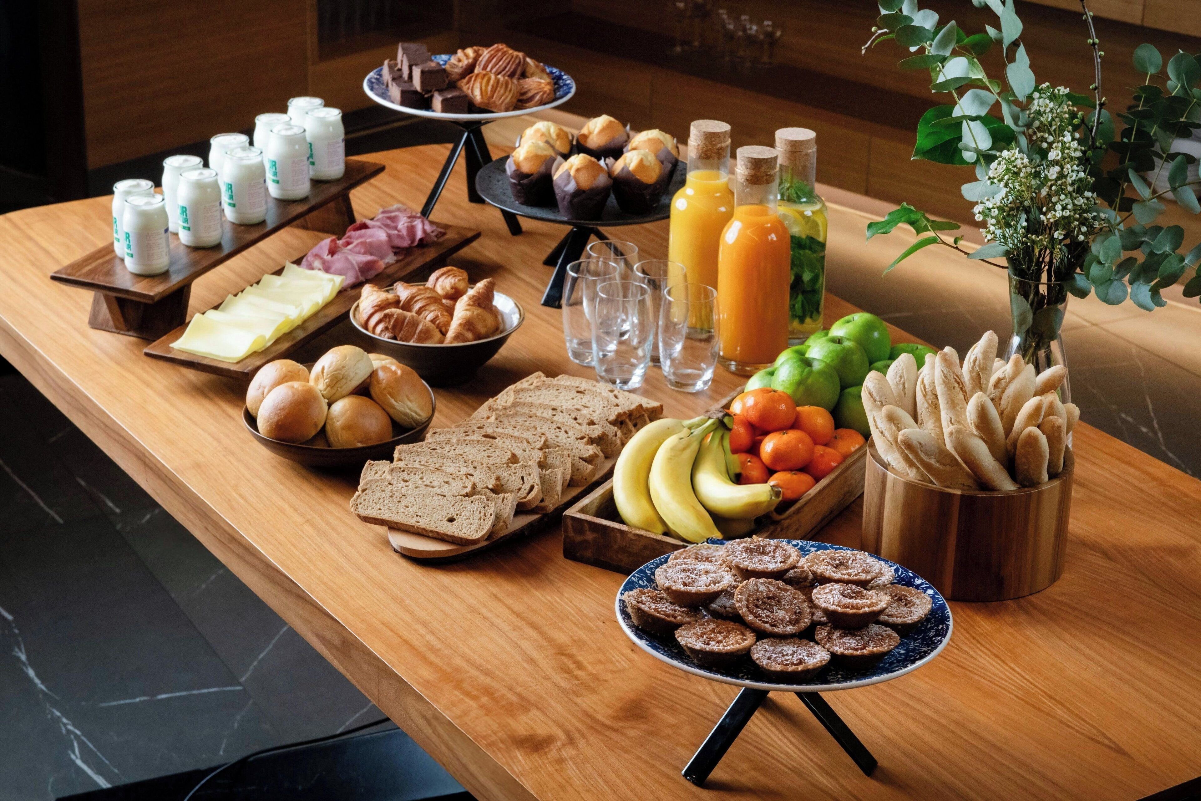 A breakfast buffet with various food items and beverages.