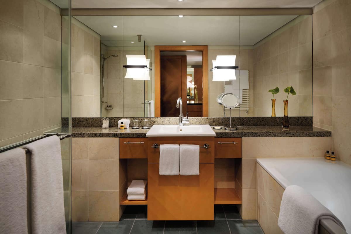 separate bathtub and shower, rainfall showerhead, designer toiletries