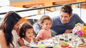 Enjoy a casual meal with family at this outdoor dining table overlooking the balcony.