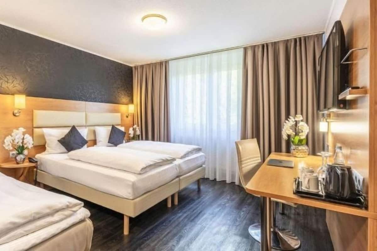 Hypo-allergenic bedding, desk, laptop workspace, blackout curtains