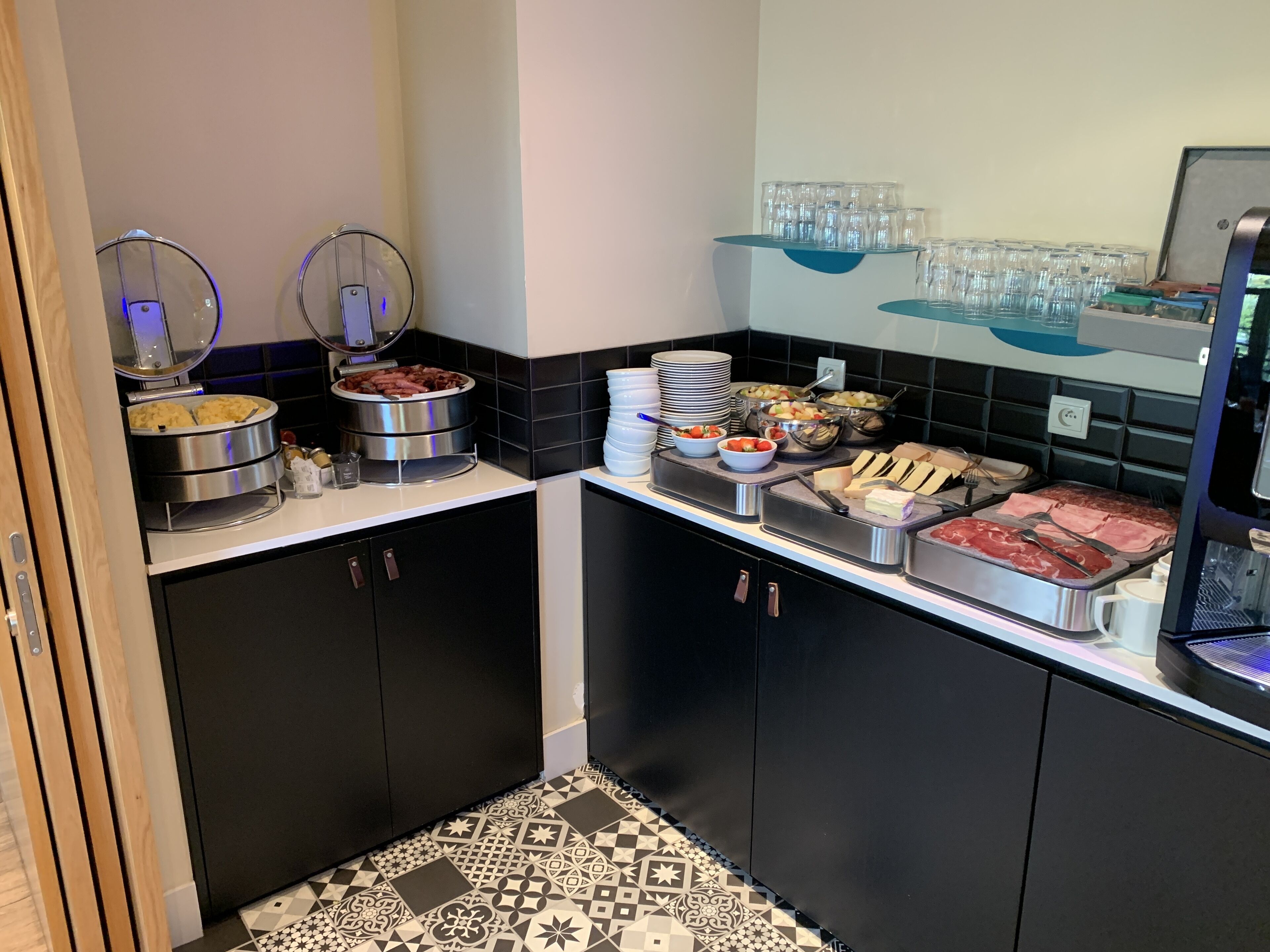A buffet setup with various food items and utensils.
