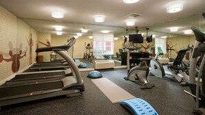 A gym with treadmills, elliptical machines, and exercise balls. - MainStay Suites Raleigh - Cary (Cary)