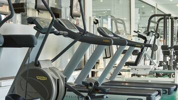 A gym with multiple treadmills and exercise machines.