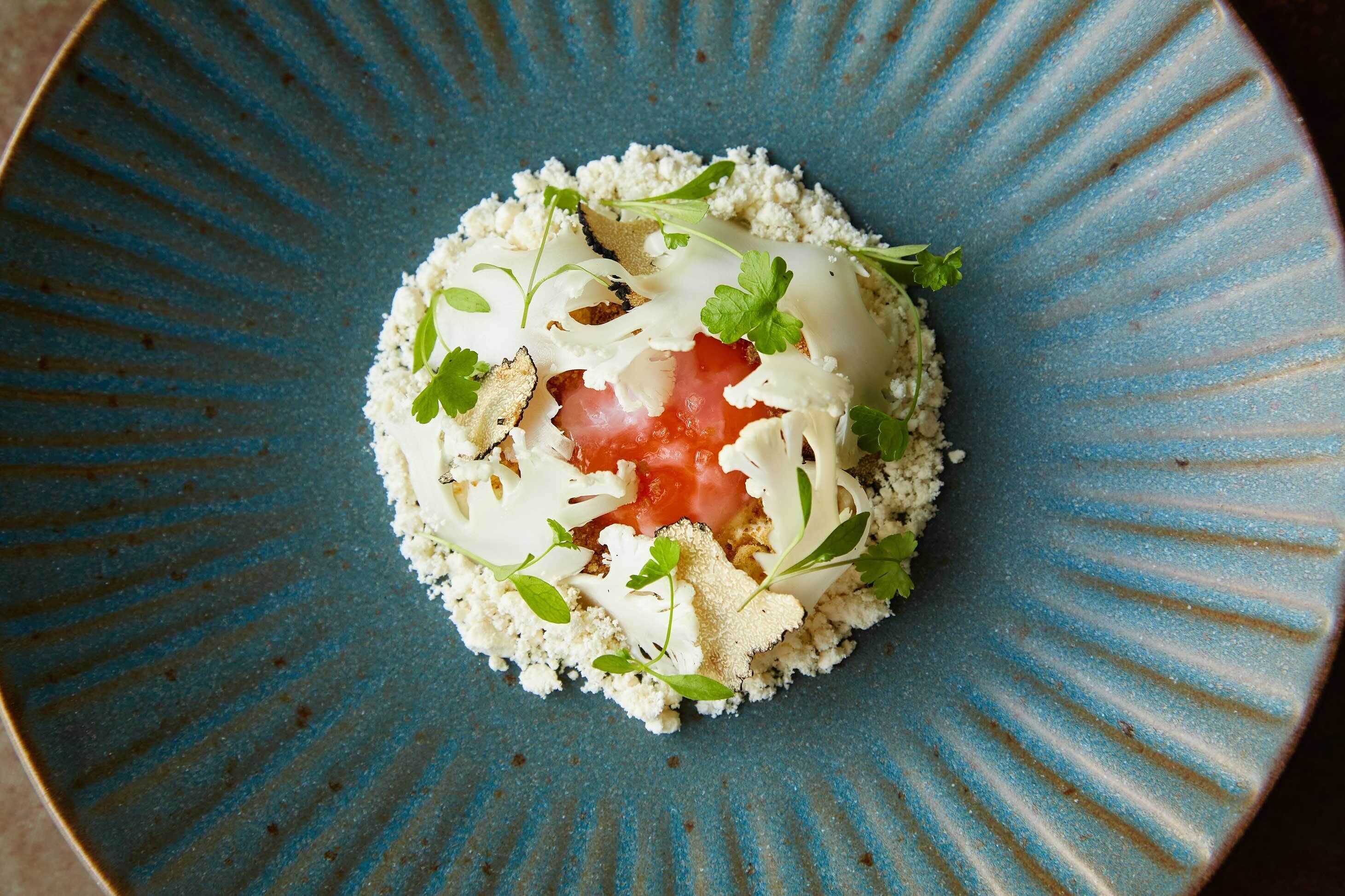 A blue ceramic plate with a food dish.