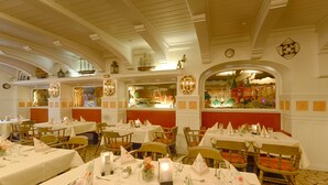 A restaurant with multiple tables set for dining, featuring white tablecloths, neatly arranged cutlery, and candle centerpieces. - Hotel Jensen (Lübeck)