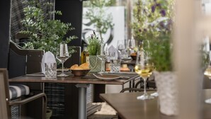 Tavola imbandita con calici da vino, una bottiglia e pane.