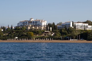 On the beach, sun-loungers, beach umbrellas, beach bar