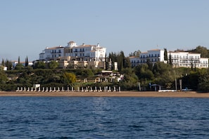 On the beach, sun-loungers, beach umbrellas, beach bar