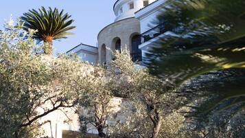 A building with a circular tower, arched windows, and a balcony.