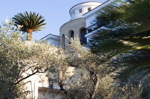 A building with a circular tower, arched windows, and a balcony.