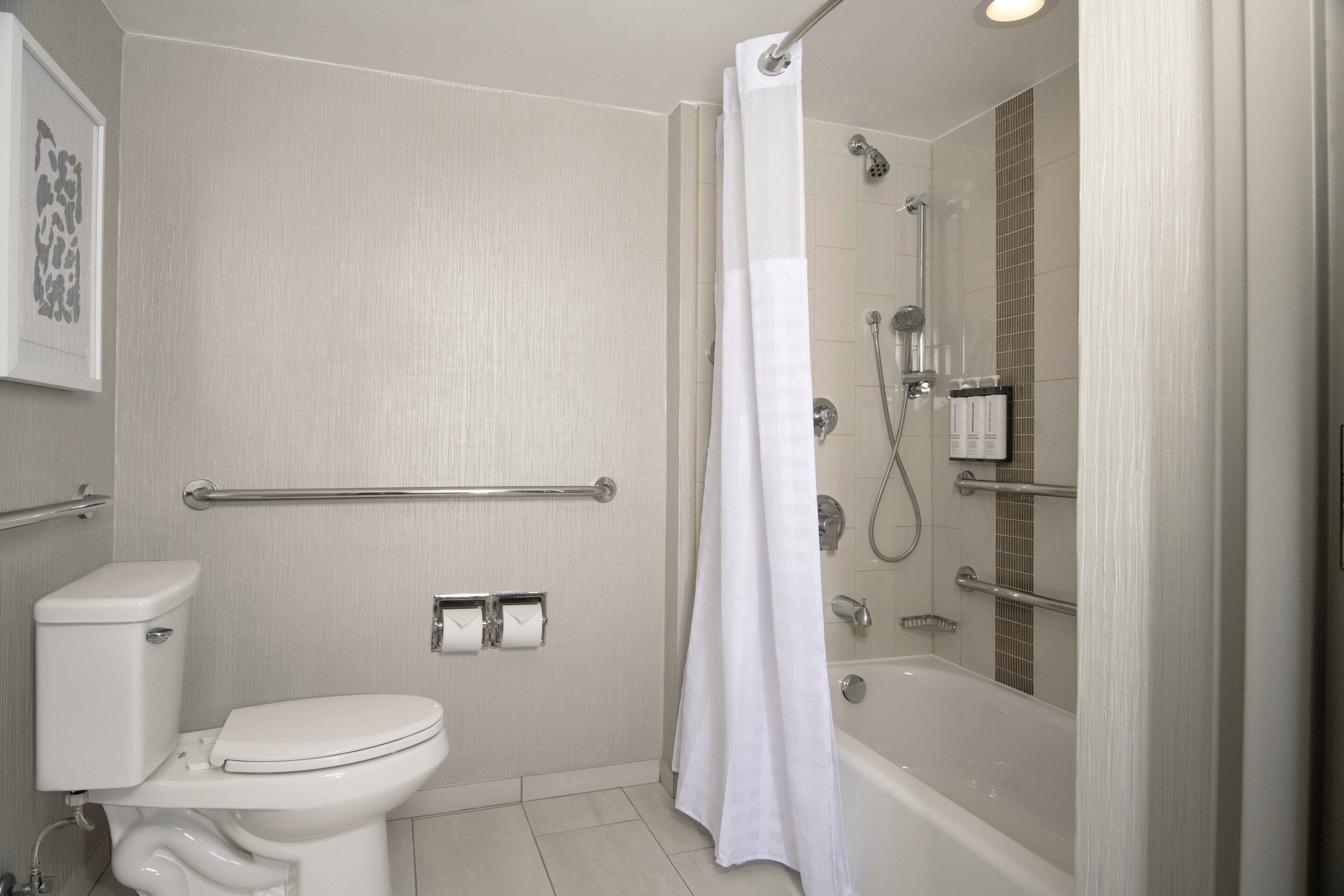 A bathroom with a toilet, a shower, and a bathtub.