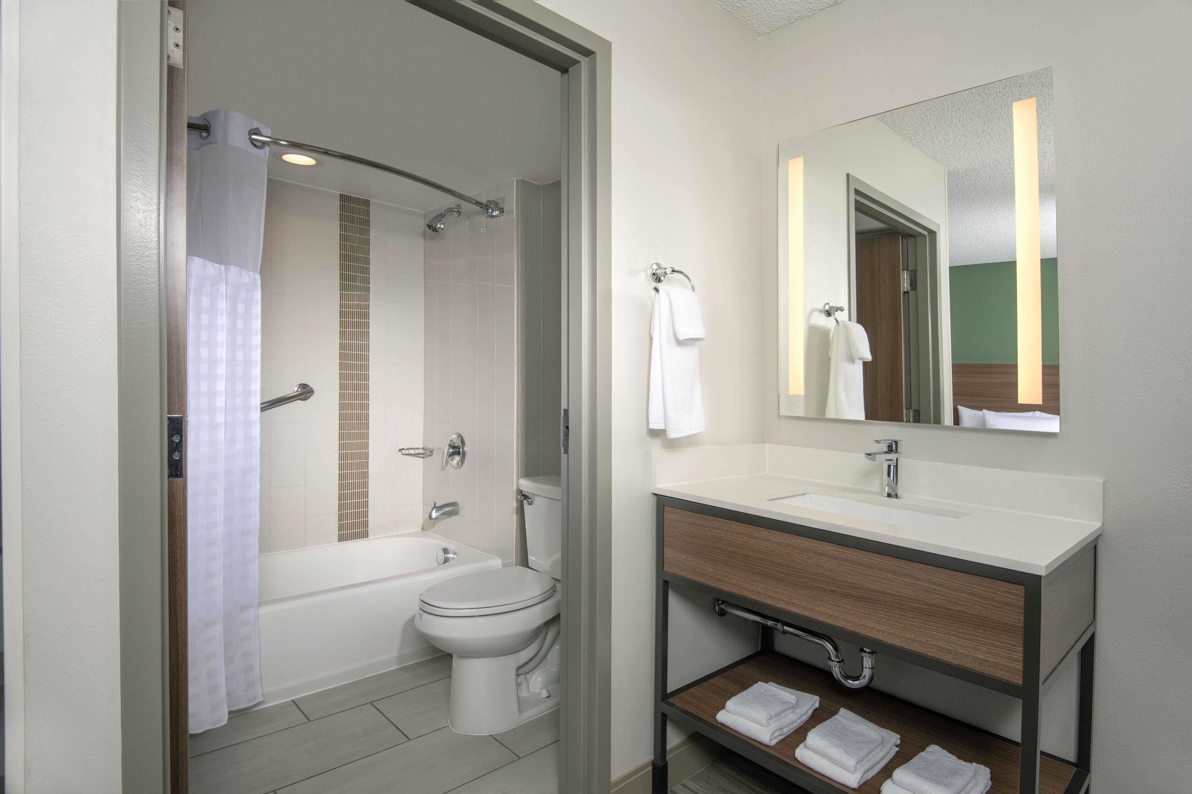 designer toiletries, hair dryer, towels