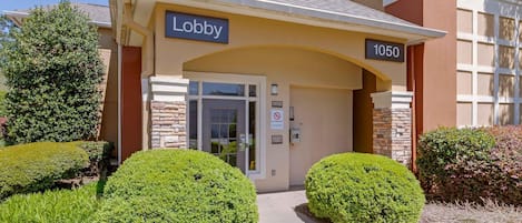 A building with a sign reading 'Lobby' and the number '1050' above the entrance.