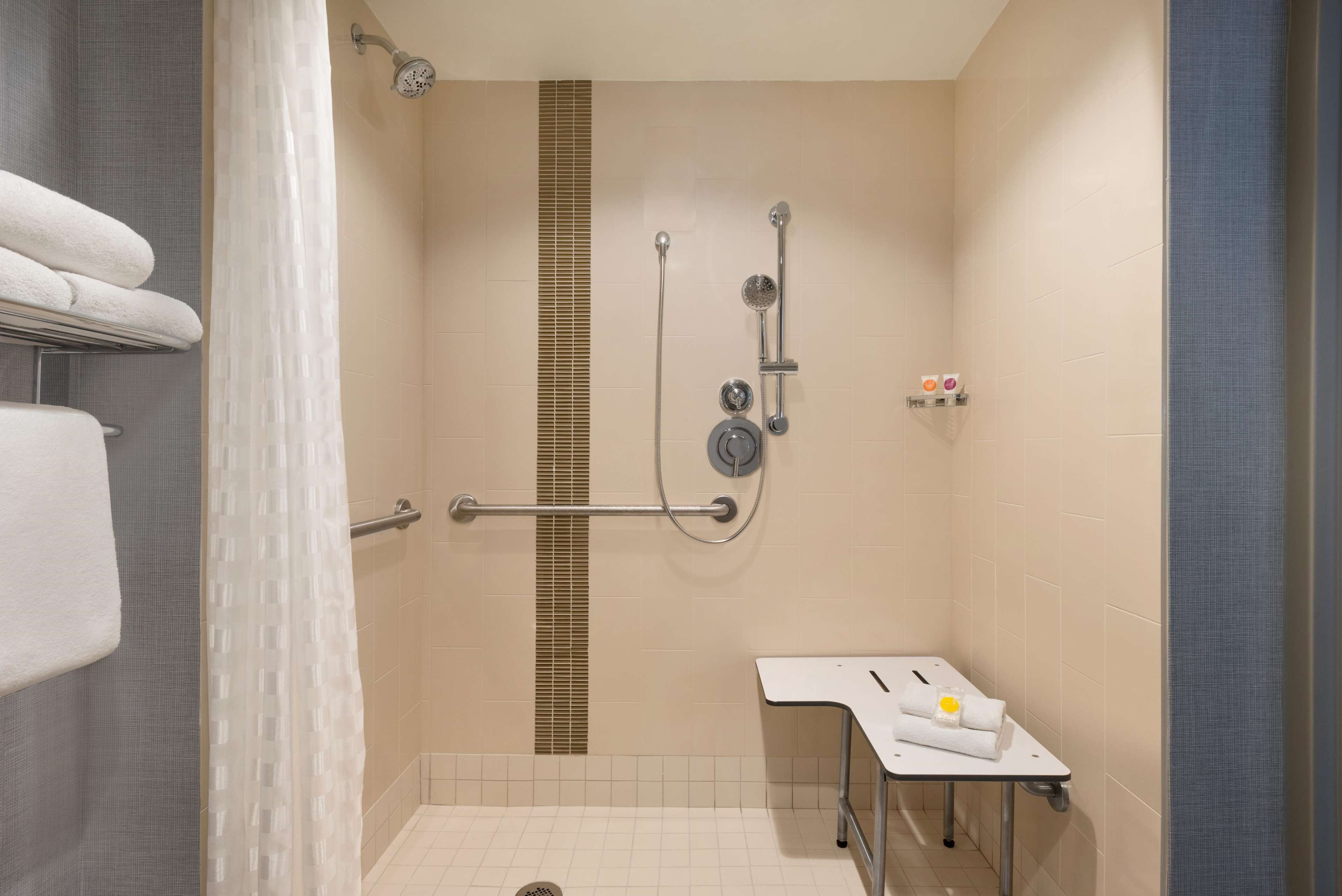 combined shower/bathtub, designer toiletries, hair dryer, towels