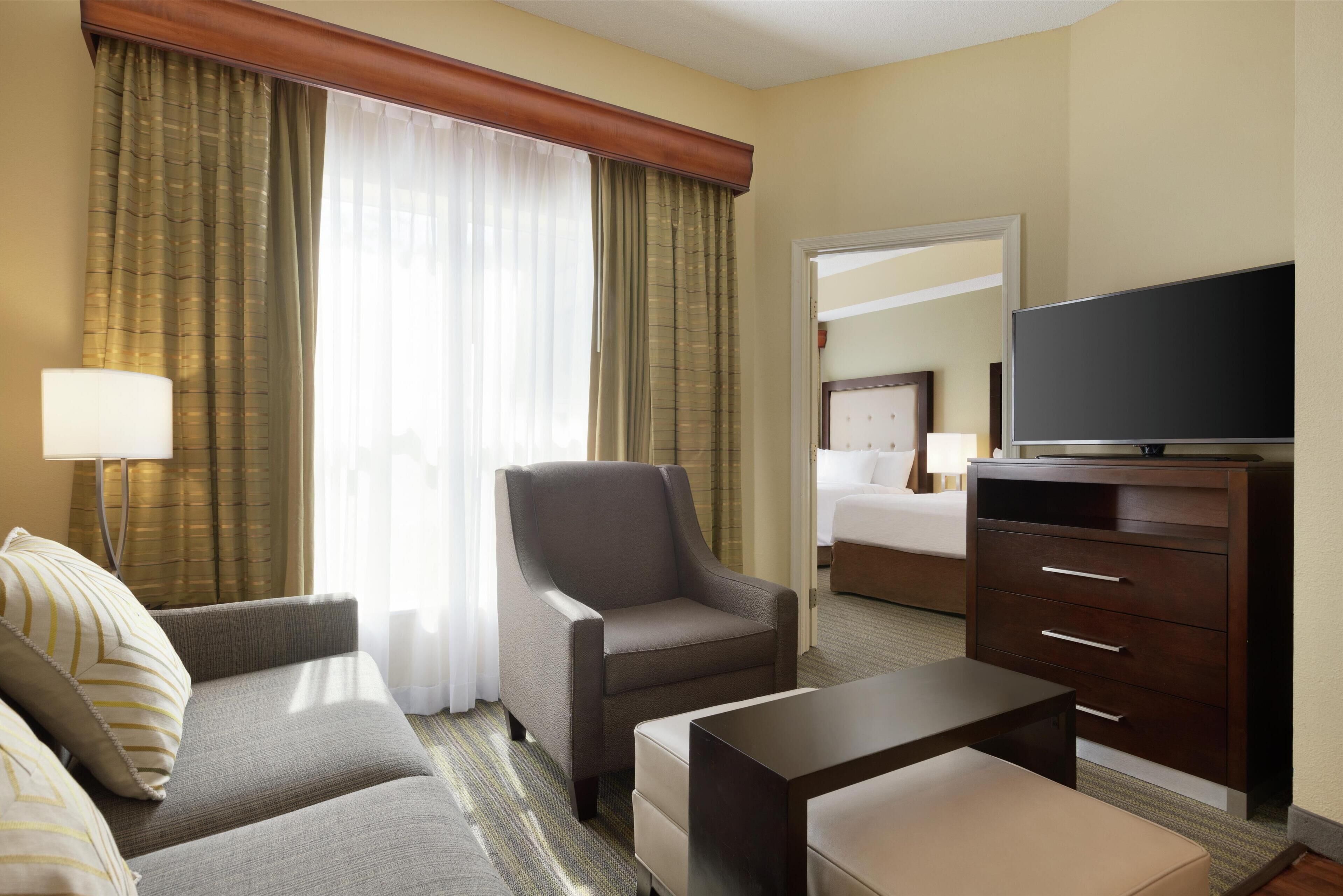 suite, non smoking | living area | 27-inch lcd tv with cable channels, tv, mp3 dock