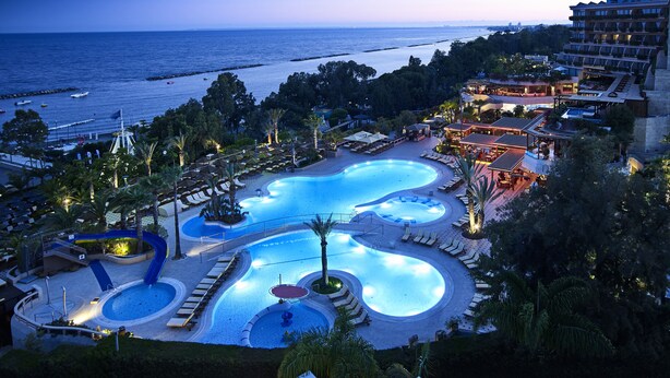 A resort with multiple swimming pools, a beach view, and a large building with balconies. - Four Seasons Hotel (Limassol)