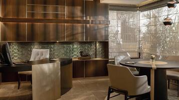 A modern kitchen with a central island, built-in wooden cabinets, and a herringbone tile backsplash.
