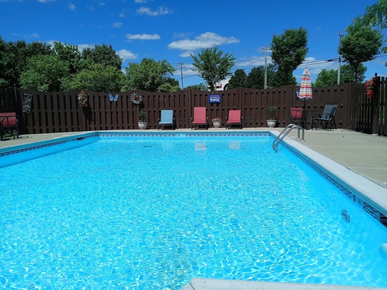 seasonal outdoor pool, pool umbrellas, pool loungers