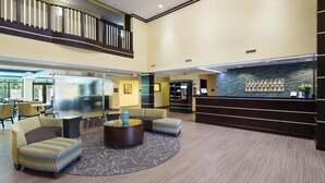 A lobby with a reception desk, seating area, and a staircase. - Best Western Plus Birmingham Inn & Suites (Birmingham)