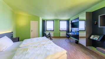 Premium bedding, desk, laptop workspace, blackout drapes
