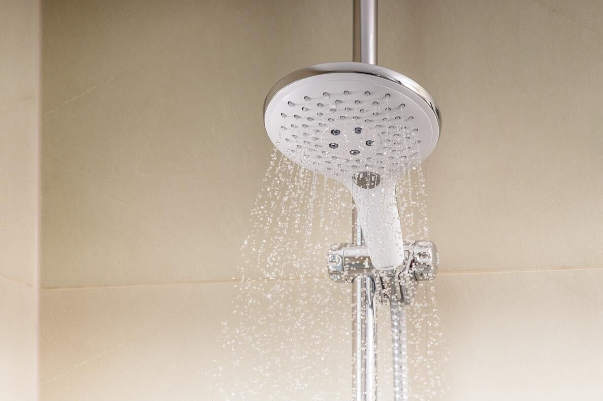 A showerhead with water flowing from it.