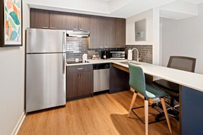 A modern kitchen with a refrigerator, microwave, and dishwasher. - HYATT house Boston/Burlington (Burlington)