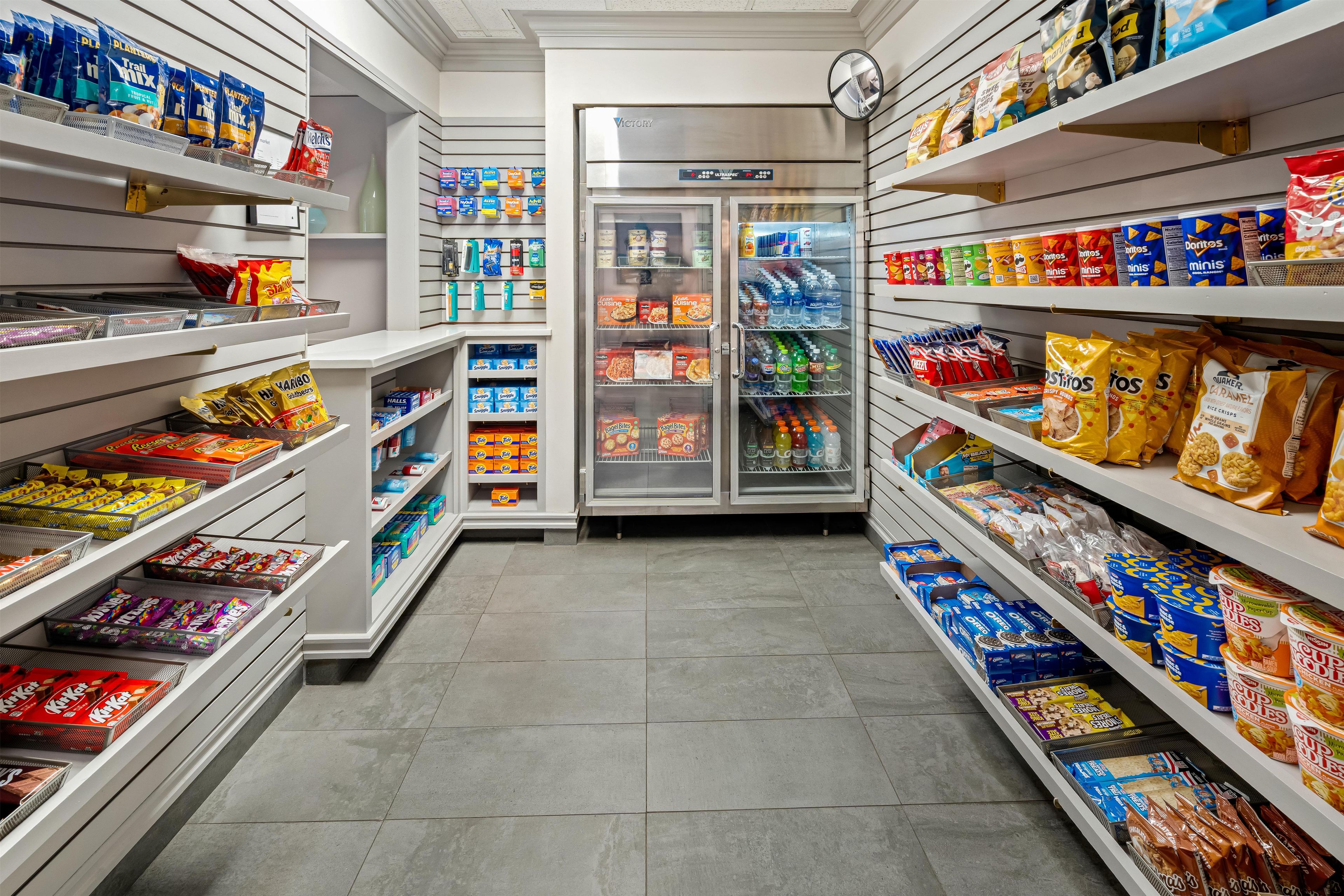 A grocery aisle with shelves stocked with snacks, beverages, and packaged goods.