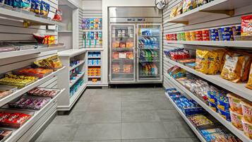 A grocery aisle with shelves stocked with snacks, beverages, and packaged goods.