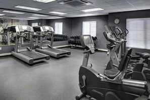 A gym with treadmills, elliptical machines, and dumbbells. - HYATT house Boston/Burlington (Burlington)