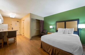 A hotel room with a bed, desk, chair, and a green accent wall. - Extended Stay America Suites Chicago Schaumburg Conv Center (Schaumburg)