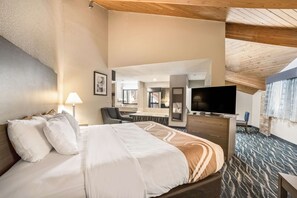 A hotel room with a bed, a desk, a television, and a bathroom. - Quality Inn Effingham North (Effingham)