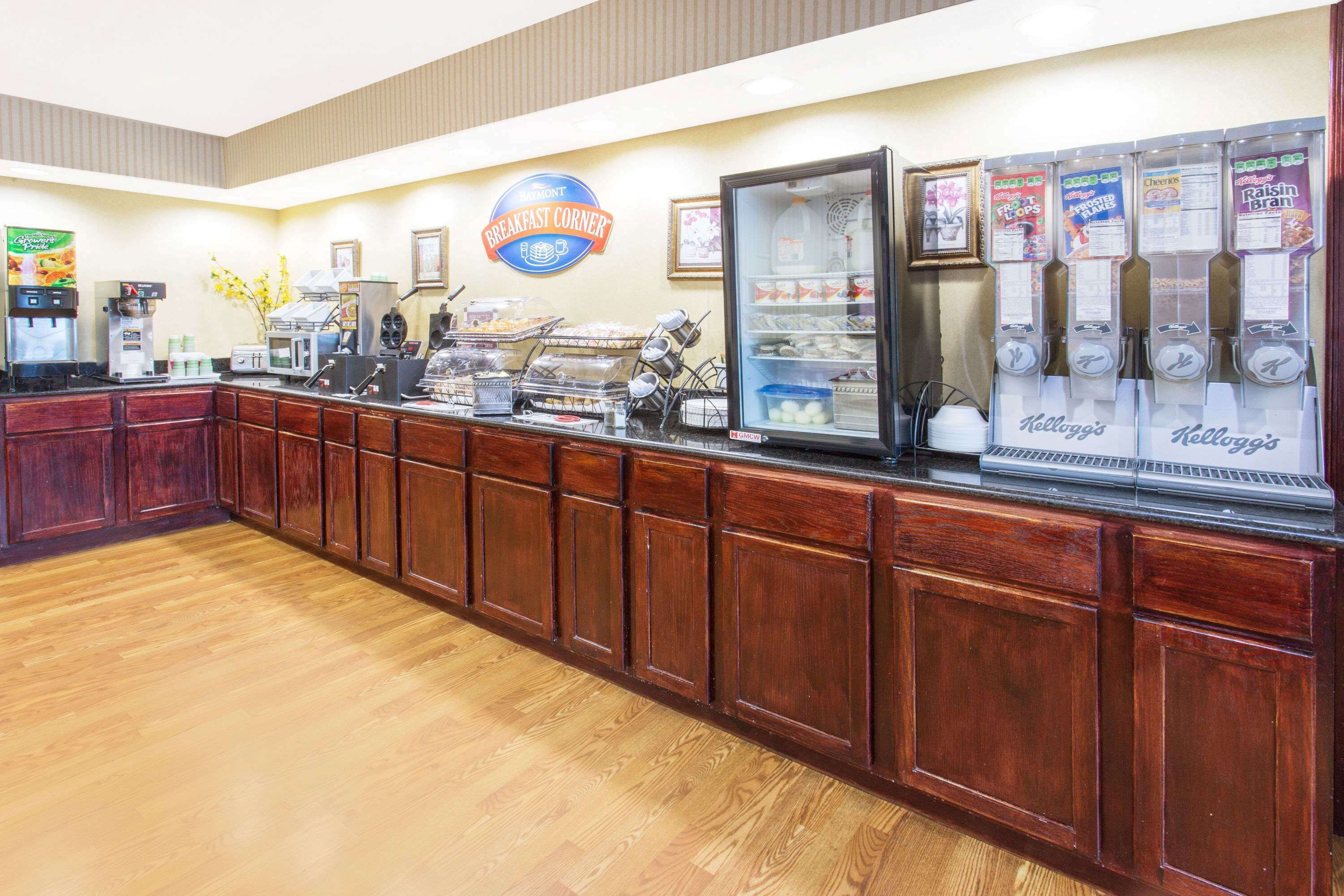 A breakfast counter with a coffee machine, cereal dispensers, and a refrigerated display.