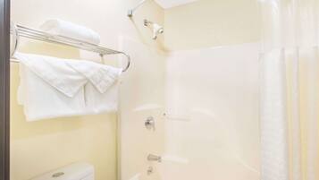 A bathroom with a toilet, a bathtub, and a shower.
