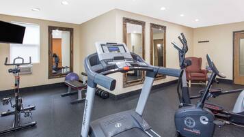 A gym with treadmills, stationary bikes, and weight machines.