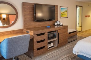 A hotel room with a wooden desk, a flat-screen TV, a microwave, a coffee maker, and a bed. - Hampton Inn Pensacola-Airport (Cordova Mall Area) (Pensacola)