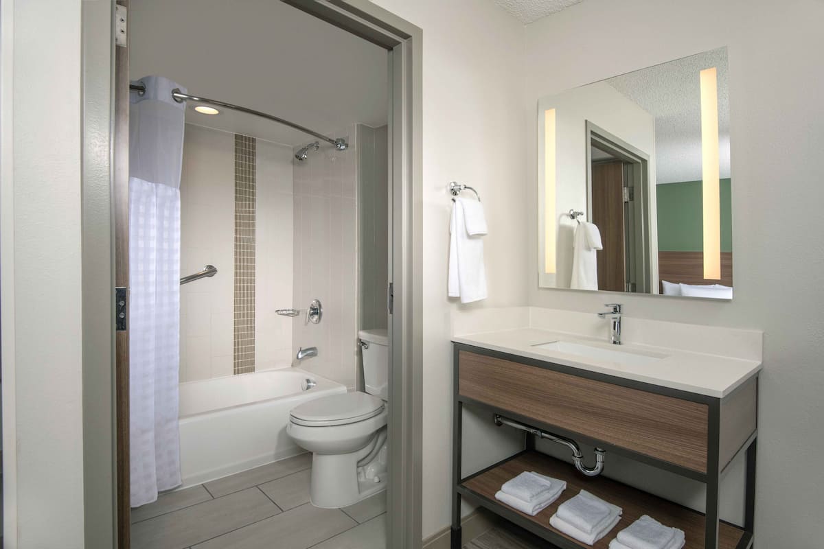 designer toiletries, hair dryer, towels