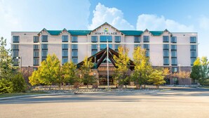 A multi-story hotel with a prominent entrance, a green roof, and a flagpole. - Hyatt Place Denver South/Park Meadows (Lone Tree)
