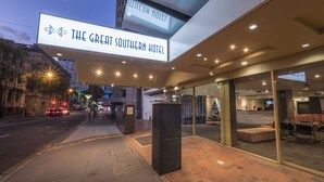 The exterior of The Great Southern Hotel with a modern design, a reception area, and a visible Christmas tree. - Great Southern Hotel Brisbane (Brisbane)