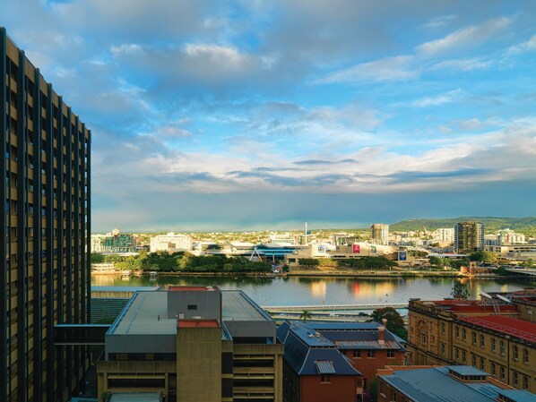 A cityscape with a river, modern buildings, and a mix of architectural styles.