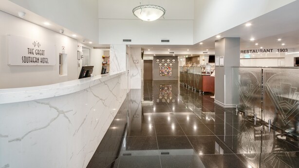 A hotel lobby with a reception desk, a sign for 'The Great Southern Hotel', and a restaurant named 'Restaurant 1903'. - Great Southern Hotel Brisbane (Brisbane)