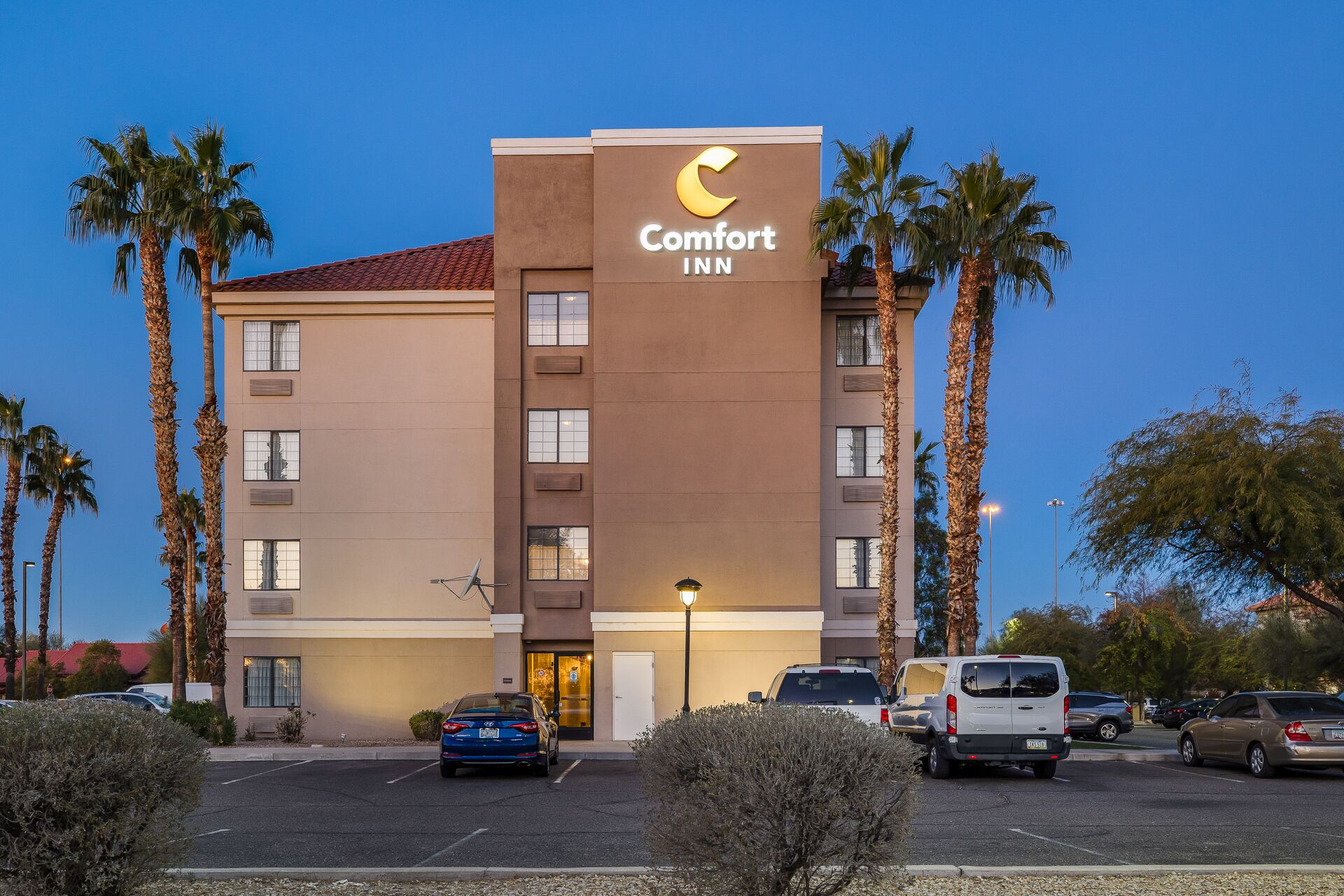 A Comfort Inn hotel with a modern design, featuring a prominent crescent moon logo on the facade.