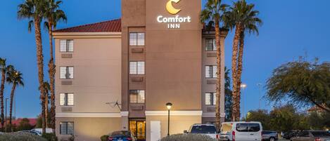 A Comfort Inn hotel with a modern design, featuring a prominent crescent moon logo on the facade.