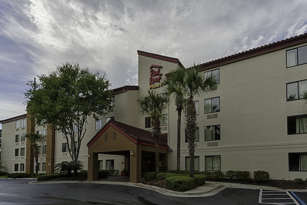 A multi-story hotel with a flat roof and a central entrance.