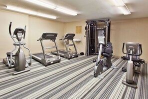 A hotel fitness room with treadmills, an elliptical, and a weight machine. - Sonesta Simply Suites Knoxville (Knoxville)