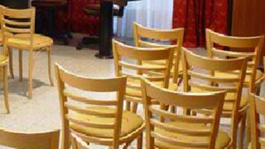 A conference room with wooden chairs, a table, and red curtains. - Reina Victoria Suites & Towers (Mendoza)