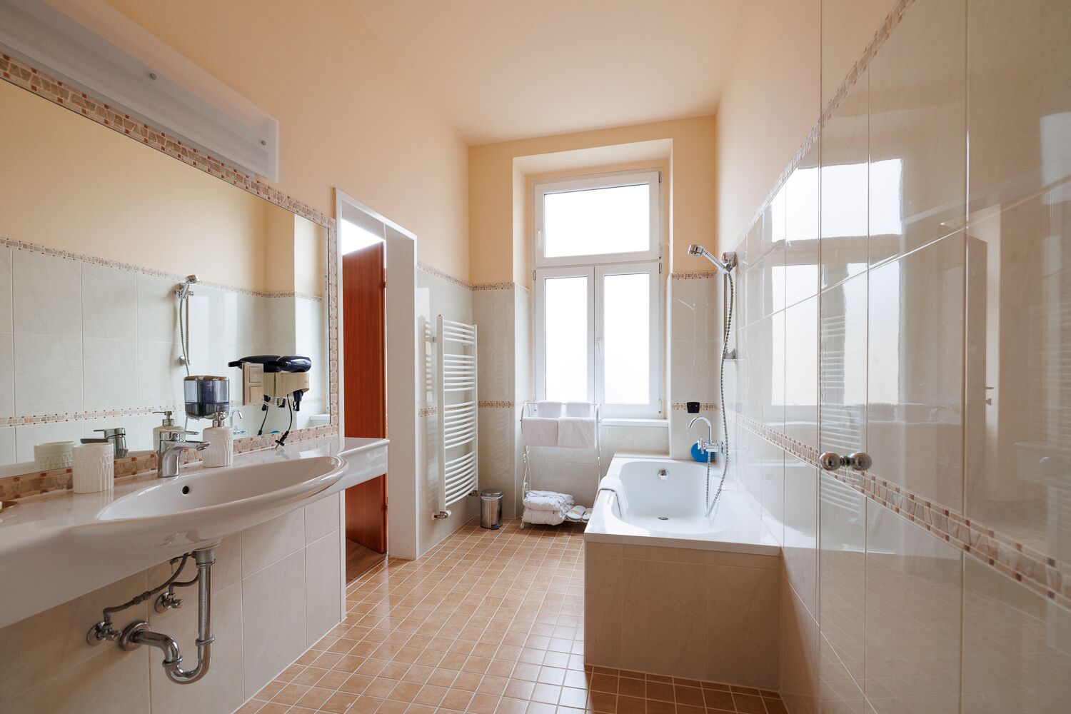 family apartment | bathroom | designer toiletries, hair dryer, bathrobes, slippers