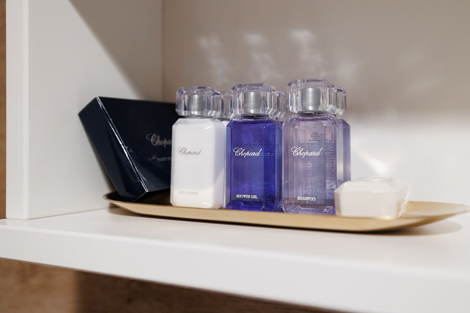 designer toiletries, hair dryer, bathrobes, slippers