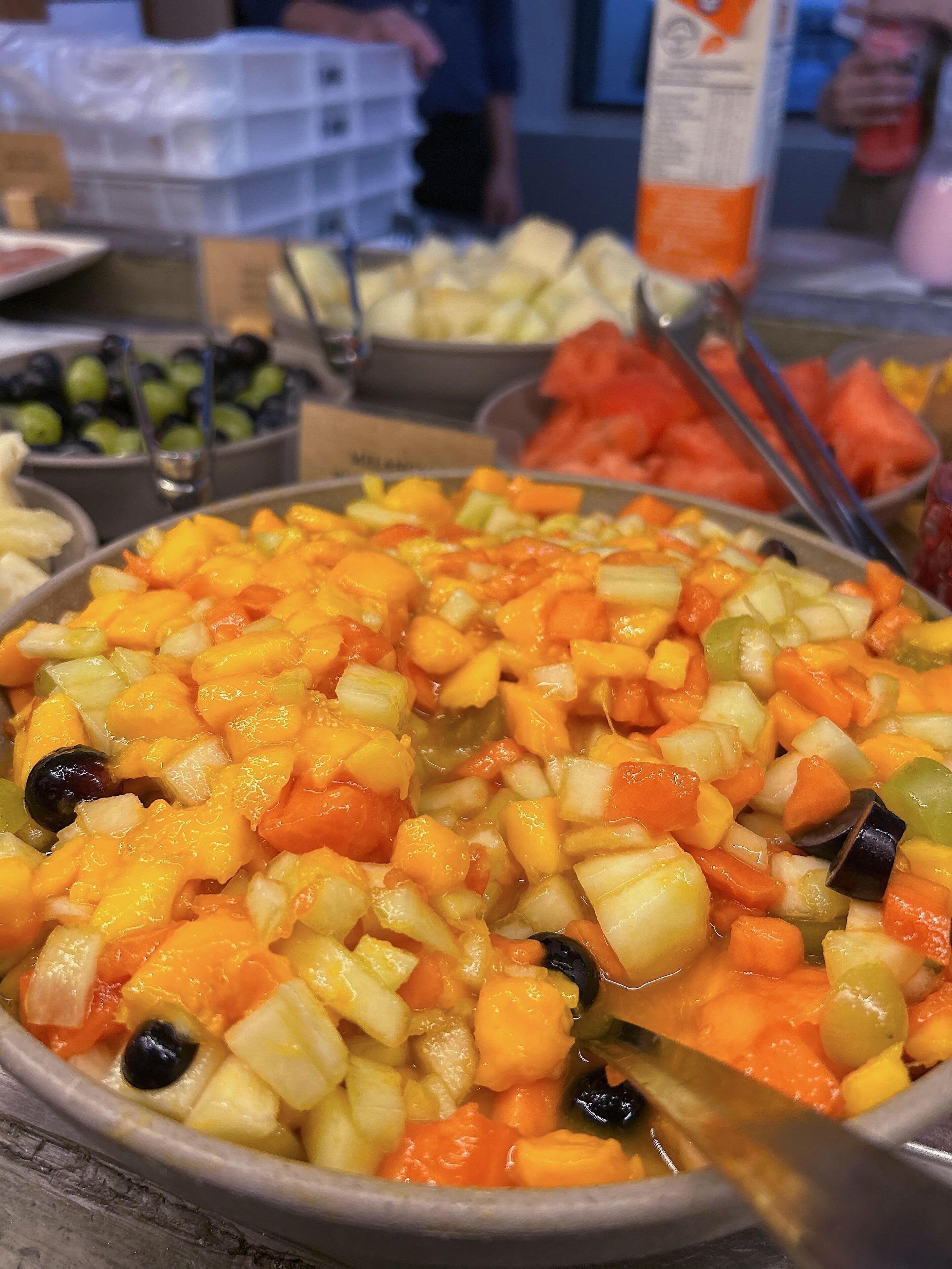 A buffet with various fruits and vegetables.