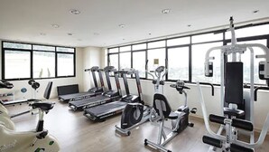 A gym with treadmills, stationary bikes, and weight machines.