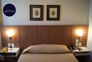 Relax in a serene space with a comfortable bed, bedside tables, and framed artworks.